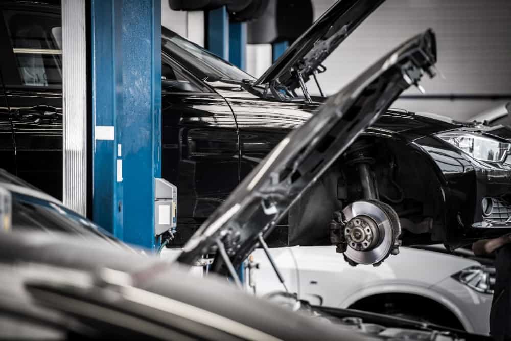 Cars in a garage with their hoods up