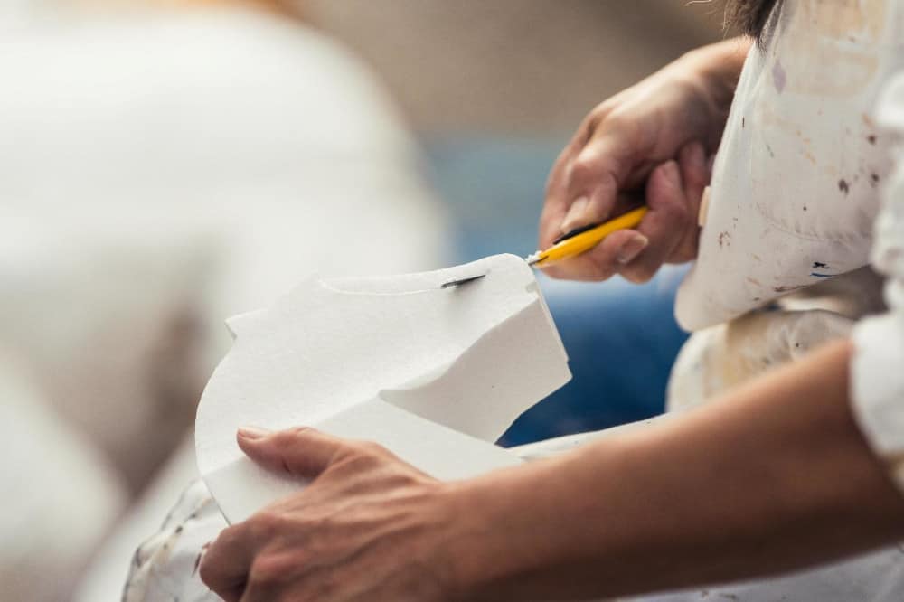 Cutting upholstery foam with a knife.