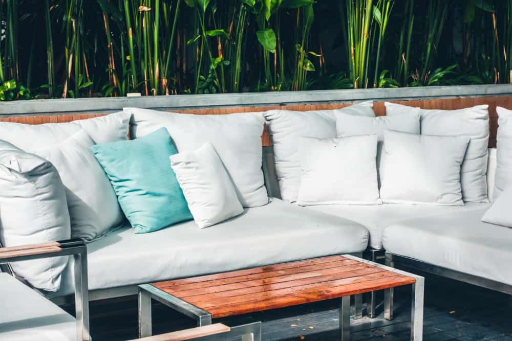 Outdoor sectional with gray seat cushions and back pillows