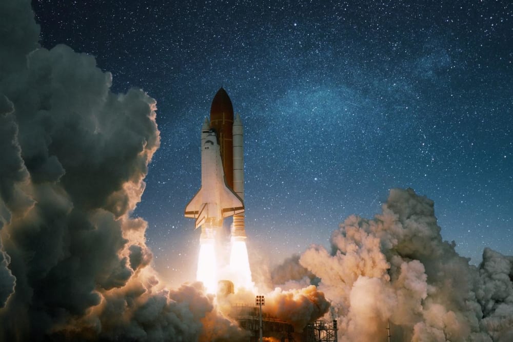 Rocket launching into space surrounded by clouds