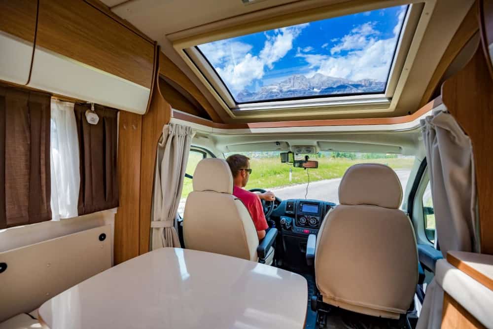 Inside view of a motorhome looking from the back towards the driver.