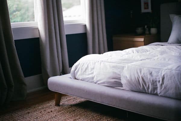 White bed next to window