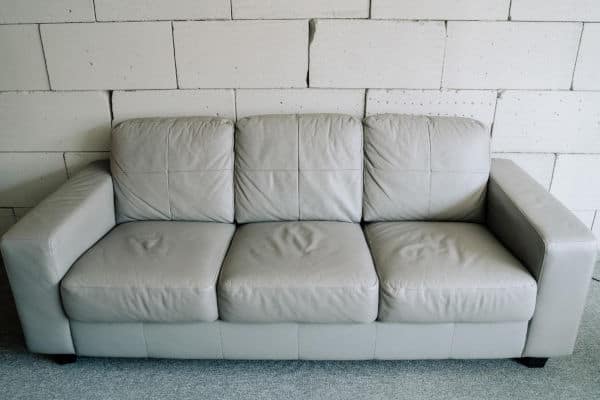 A couch with well-worn cushions