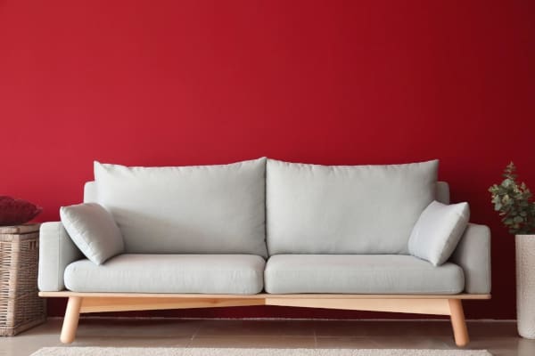 A couch with gray cushions and pillows in a room