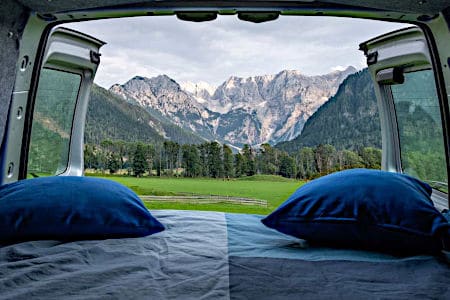 Mattress with Blue Bedsheet and Pillows in the Van