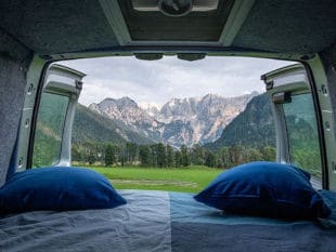 Mattress with Blue Bedsheet and Pillows in the Van