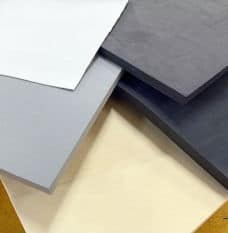 Black, white, and various shades of grey sheets of closed cell foam