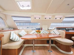 Custom circular boat cushions at a table on a large boat