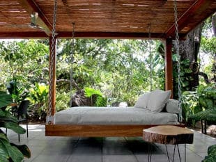 Hanging Wooden Bed with White Mattress and Cushions