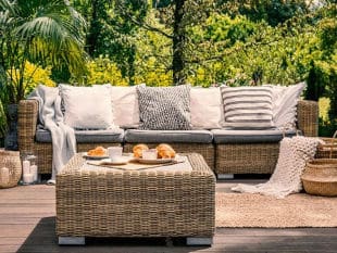 Wicker Couch with Grey Cushions in the Garden