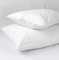 Two white down pillows stacked on top of each other