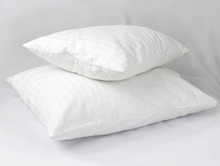 Two white down pillows stacked on top of each other