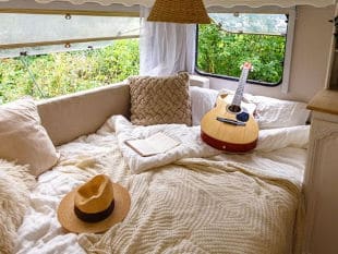 White Mattress for Van with Guitar, Book, and Hat