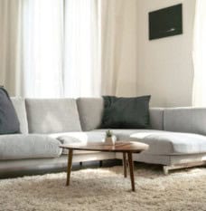 Gray modern Couch with square shaped seat and back cushions