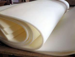 Thin white foam sheets rolled up in layers