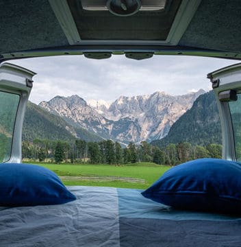 Mattress with Blue Bedsheet and Pillows in the Van