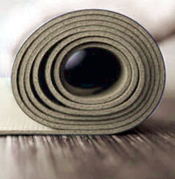 Beige thin foam partially rolled up on wood flooring