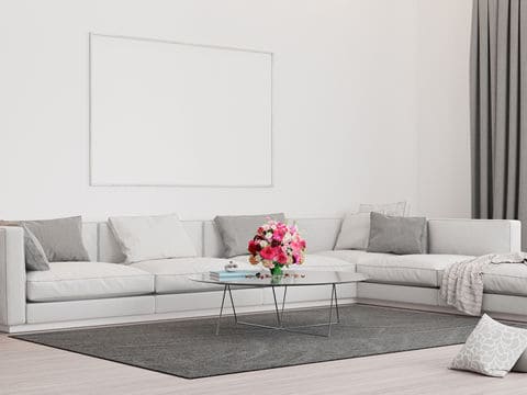 White living room with grey couches, rug, and curtains