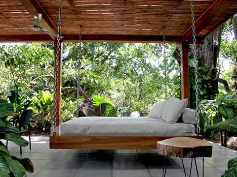 Hanging Wooden Bed with White Mattress and Cushions