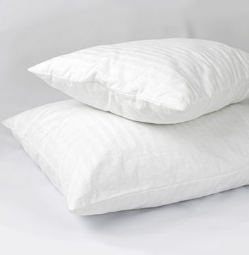 Two white down pillows stacked on top of each other