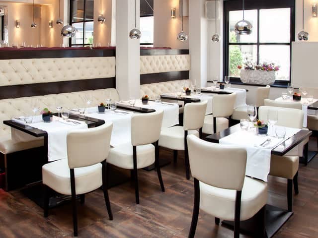 restaurant seating with white chairs and booths