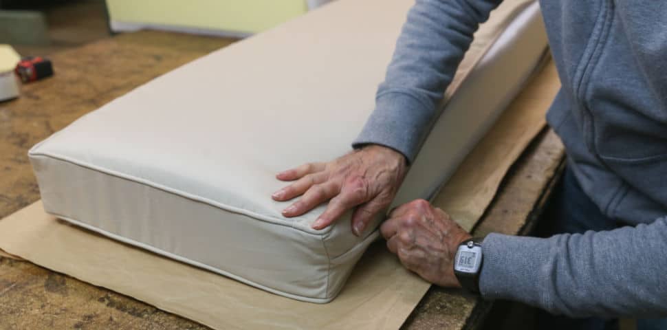 Designer zipping a cover onto a cushion