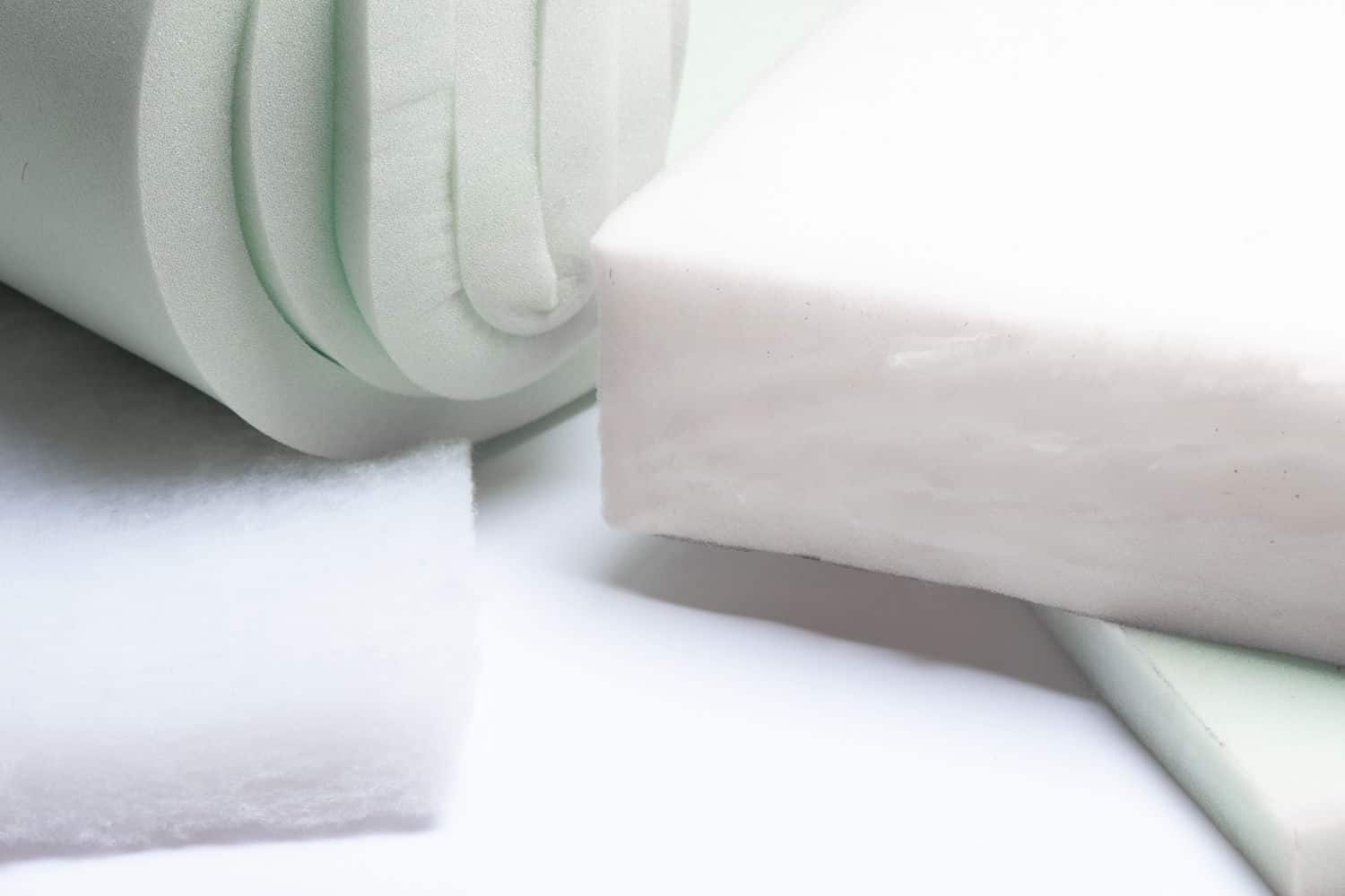 Fire Retardant Foam rectangle next to thin foam rolled up into tight roll