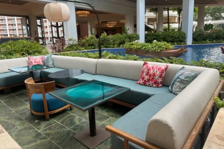 Wicker couches with yellow cushions on deck in front of fireplace