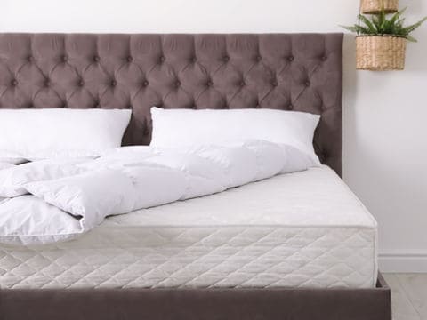 Brown Bed with White Mattress and Pillows