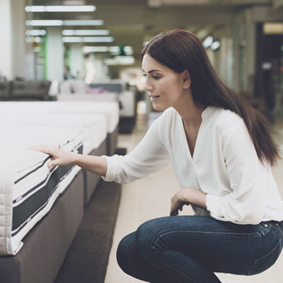 Shopper feeling the high quality of a clearance Organic Mattress