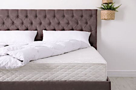 Brown Bed with White Mattress and Pillows