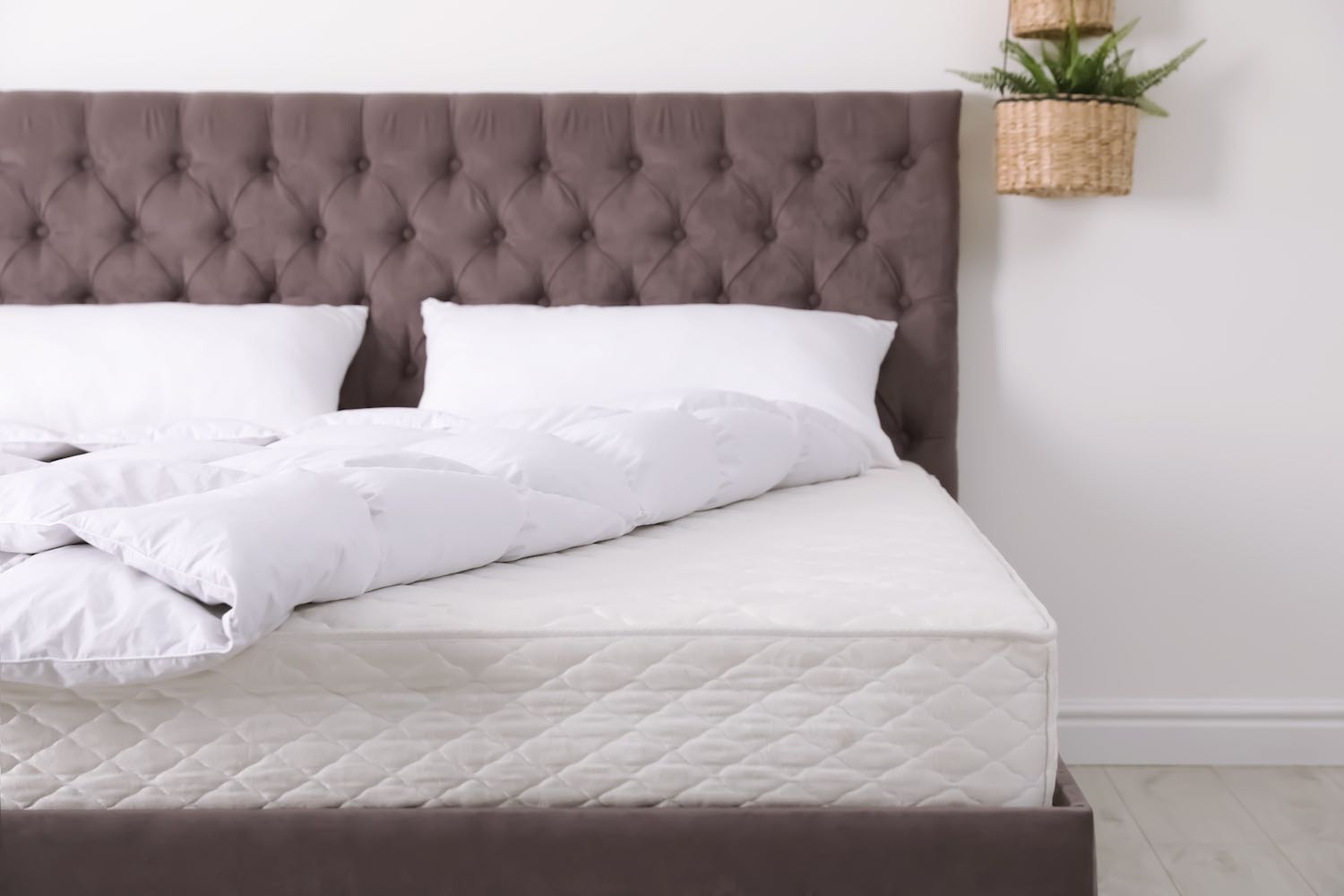 Brown Bed with White Mattress and Pillows