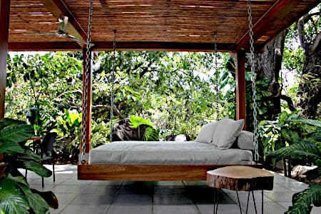 Hanging Wooden Bed with White Mattress and Cushions