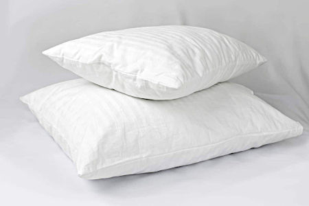 Two white down pillows stacked on top of each other