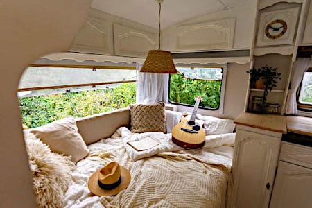 White Mattress for Van with Guitar, Book, and Hat