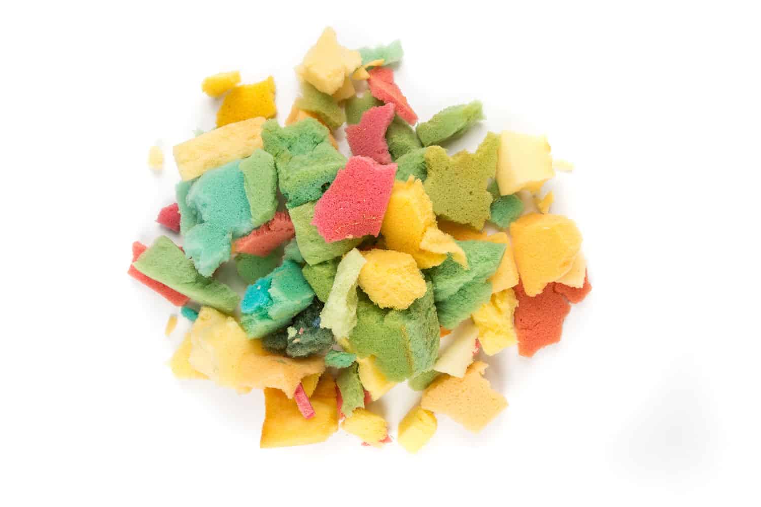 Various small foam scraps in a pile on a white background